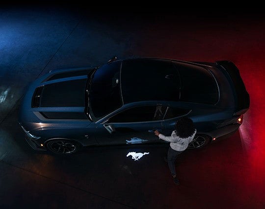 2024 Ford Mustang® Dark Horse™ model with a driver approaching the vehicle | Birdnow Motor Trade in Oelwein IA