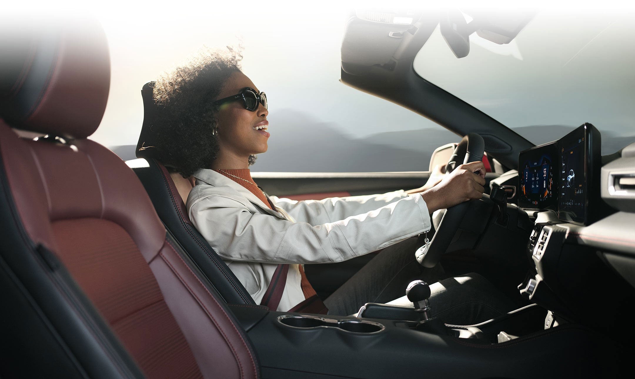 Person sitting in the driver’s seat of a 2024 Ford Mustang® convertible | Birdnow Motor Trade in Oelwein IA